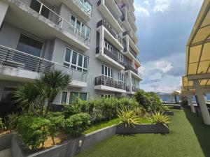 an apartment building with a garden in front of it at The Octagon Ipoh City Centre Leisure Suite in Ipoh