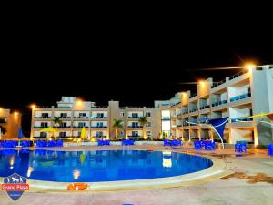 a large swimming pool in front of a hotel at Grand Plaza 6 Octobar in Qaryat ash Shamālī