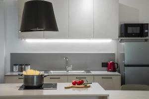 a kitchen with a sink and a pot on a counter at Villa Stanga - Gardaslowemotion in Tenno