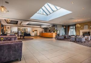 a large lobby with a skylight and a waiting room at Arklow Bay Hotel in Arklow