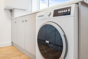 a white washing machine in a white laundry room at Feels like Home, 4-Bedroom in Stanley, Sleeps 7 in Stanley