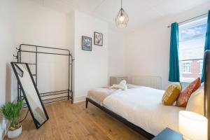a bedroom with a bed and a window at Feels like Home, 4-Bedroom in Stanley, Sleeps 7 in Stanley