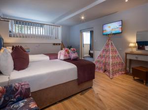 a bedroom with two beds and a christmas tree at Arklow Bay Hotel in Arklow