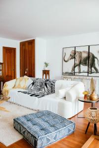 a living room with a white couch and an elephant picture at Loft del Sol in Peñíscola +77 photos