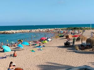 a large group of people on a beach at La Mallada in Sant Jordi