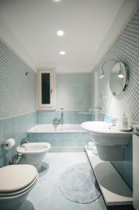 a bathroom with a toilet and a sink and a tub at Taormina Chic Apartment in Taormina