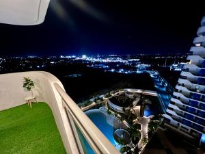 a view of a city at night from a building at Big Spacious Corner Unit at Azure North wraparound balcony in San Fernando