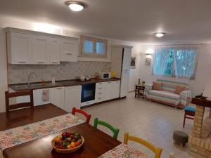 a kitchen and living room with a table and chairs at Casa sotto la Quercia in Citta' Sant'Angelo
