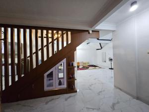 a hallway with a staircase in a house at IM Merapi Homestay in Ngaglik