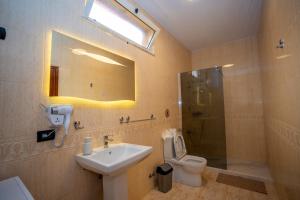 a bathroom with a sink and a toilet and a shower at Hotel Pepe in Shkodër +16 photos