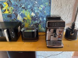 a coffee machine sitting on a table next to a coffee maker at Charming alps apartment perfect for walk/cycle/ski in Eschenbach