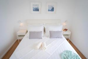 a bedroom with a white bed with two pillows at Blue Lagoon house in Hvar