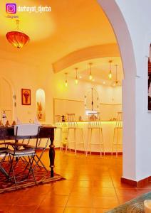 a living room with an archway and a table and chairs at Dar hayat in Djerba