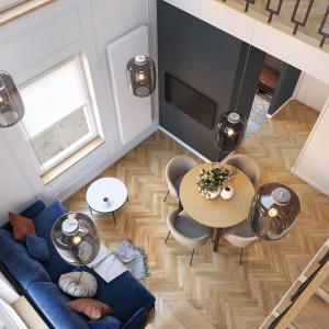 an overhead view of a living room with a blue couch and a table at Tyzenhauz Apartments Siemiradzkiego Street in Krakow