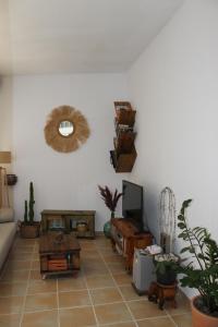 a living room with a couch and a tv at Habitación en piso compartido Room in shared flat in Torremolinos