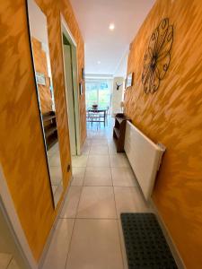 a hallway with a mirror and a tile floor at Aux pieds des pistes 4/6 personnes in Gérardmer