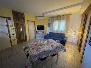 a living room with a table and a couch at Belvedere Lacinio -Casa Vacanze- in Crotone
