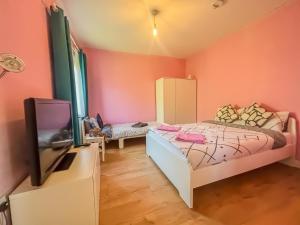 a small bedroom with a bed and a tv at 1 Bedroom Apartment By The River in High Wycombe
