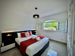 a bedroom with a large bed and a window at Quarteira Premium Villa With Pool by Homing in Cabeço de Câmara