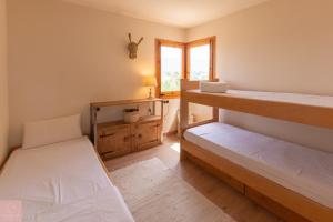 a room with two bunk beds and a window at Dúplex a Age amb piscina in Puigcerdà +15 photos