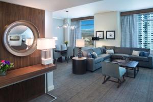 a living room with a couch and a mirror at Hyatt Regency Denver at Colorado Convention Center in Denver