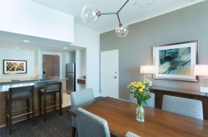 a kitchen and dining room with a table and chairs at Hyatt Regency Denver at Colorado Convention Center in Denver