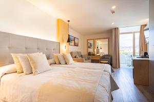Postel nebo postele na pokoji v ubytování HL Rondo Hotel