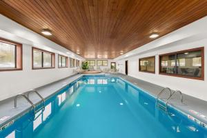 an indoor swimming pool with a wooden ceiling at Hampton Inn Lancaster in Lancaster