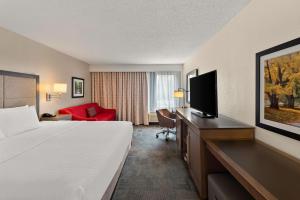a hotel room with a bed and a flat screen tv at Hampton Inn Lancaster in Lancaster