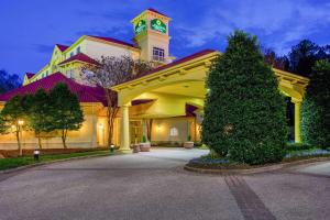 a large building with a clock tower on top of it at La Quinta by Wyndham Raleigh/Durham Southpoint in Durham