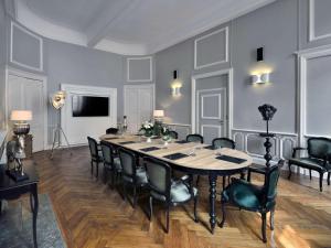 a large dining room with a table and chairs at La Cour des Consuls Hotel and Spa Toulouse - MGallery in Toulouse