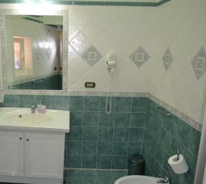 a bathroom with a sink and a toilet and a mirror at Toledo in Naples