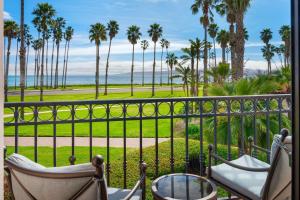 a balcony with palm trees and a view of the ocean at Hilton Santa Barbara Beachfront Resort in Santa Barbara