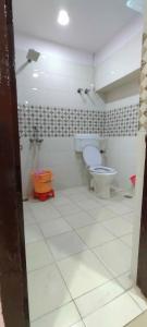 a bathroom with a toilet and a sink at Hotel Atithi Galaxy in Kānpur