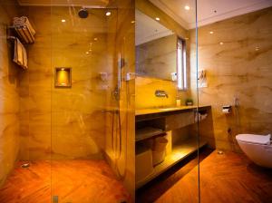 a bathroom with a shower and a sink and a toilet at Cresent Villa in Varanasi