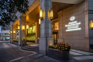 a building with lights on the side of it at Kempinski The One Suites Hotel Shanghai Downtown in Shanghai