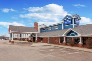 a building with a sign on top of it at AmericInn by Wyndham Peoria in Peoria