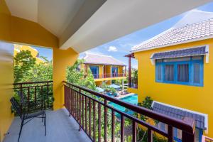a balcony with a view of a house at Chez Mimosa Rice Farm Hoi An - New address DX18, Thanh Nhut, Cam Thanh in Hoi An