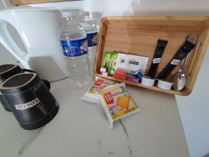 a bottle of water sitting next to a wooden box at Le Bois Charmant in Lamonzie-Montastruc