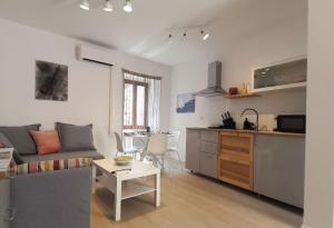 a living room and kitchen with a couch and a table at Eli i Val in Rovinj