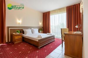 a hotel room with a bed and a desk at Hotel Allegra Balneo & SPA in Golden Sands