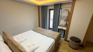 Krevet ili kreveti u jedinici u okviru objekta Avcı Palace Hotel