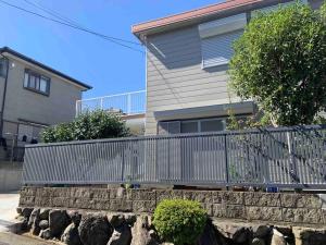 a metal fence in front of a house at 望海荘 in Hannan