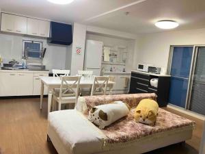 a living room with a couch and a kitchen at 望海荘 in Hannan +68 photos