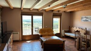 a living room with a chair and a balcony at Mirasierra II Y III in Navarredonda de Gredos