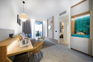 a kitchen and living room with a table and chairs at HOVIMA Suites Costa Adeje in Adeje