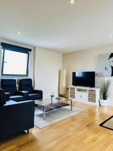 sala de estar con sofá y TV en Stylish Zone 2 city Apartment, en Londres