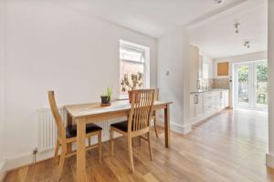 a dining room with a table and two chairs at Calderon Road in London