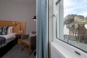 a hotel room with a window with a view of edinburgh at Apex City of Edinburgh Hotel in Edinburgh