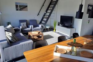 uma sala de estar com um sofá e uma mesa em Wijk de Brabander 134 em Cadzand